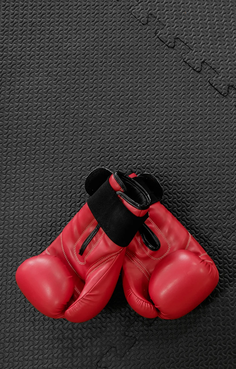boxing gloves hang on nail on texture wall with copy space for t